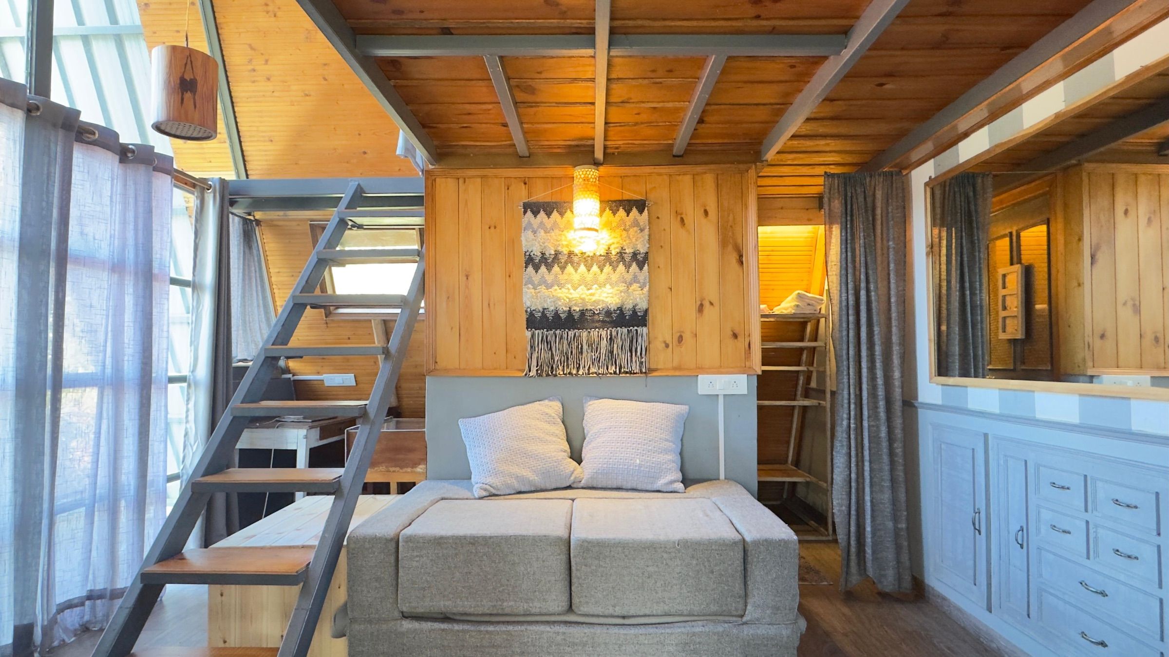 The A-frame downstairs, with the stair up to the loft on one side